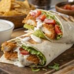 crispy chicken ranch wrap cut in half on a wooden board
